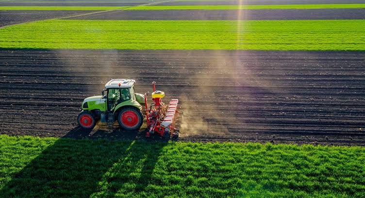 The Rise of Farming Technology in Small-Scale and Weekend Farming Modern tractor using farming technology for precision field cultivation